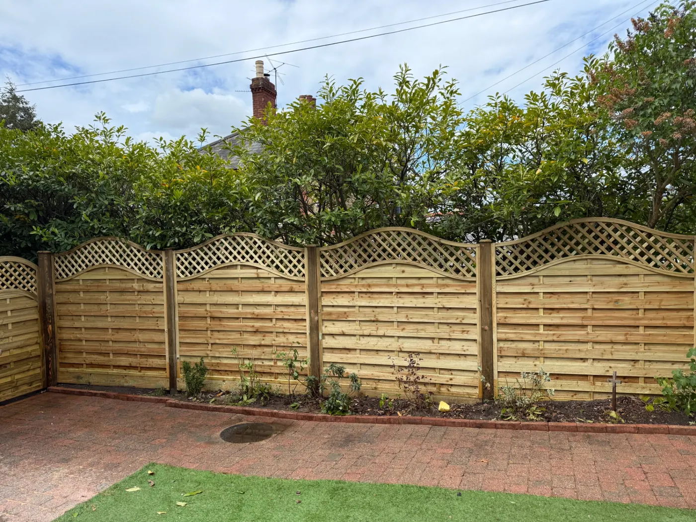 Continental style trellis top fencing in a Farnham back garden